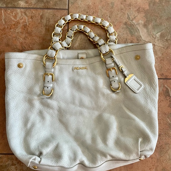 Prada Handbags - 100% Authentic  Prada beige leather with sheen. Gold Hardware